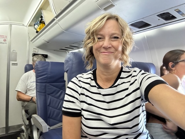 laurie-in-airplane-seat-tell-travel-tips